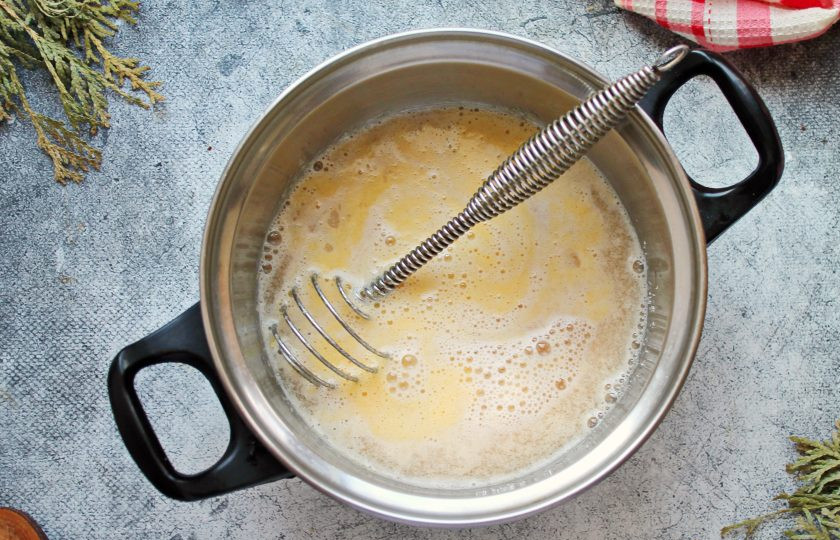 1. Этап. Яичный пунш: Влейте в кастрюлю полусладкое белое вино, перемешайте венчиком.