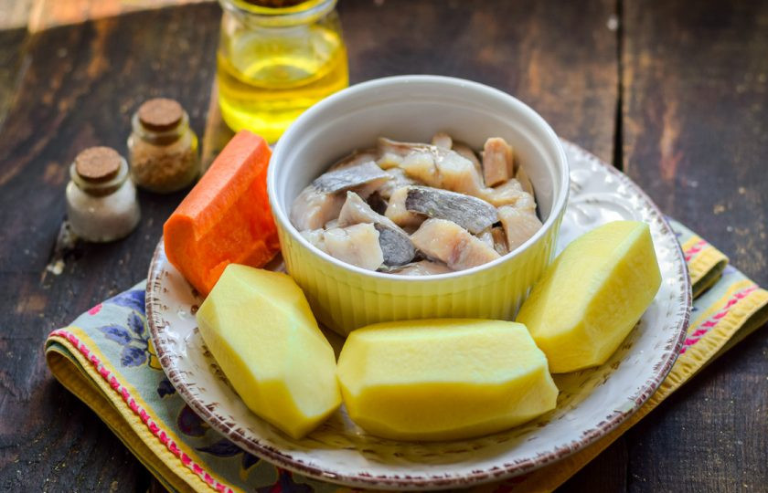 1. Этап. Селедка с картошкой в духовке: Подготовьте ингредиенты. Сельдь заранее разморозьте и почистите, нарежьте небольшими кусочками.