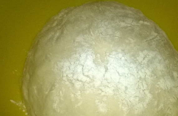 1. Этап. Хычин с домашним сыром: Приготовим тесто. В подсоленную теплую воду добавьте муку и сахар. Замесите тесто, чтобы оно не липло к рукам. Затем накройте полотенцем и дайте ему подойти.