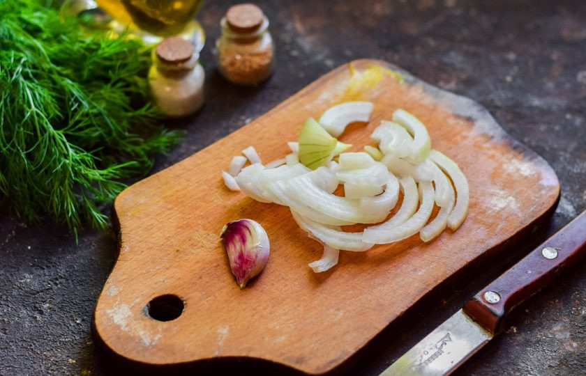 1. Этап. Свинина в рукаве с грибами: Очистите репчатый лук, сполосните и нарежьте полукольцами. Также можно добавить немного чеснока.