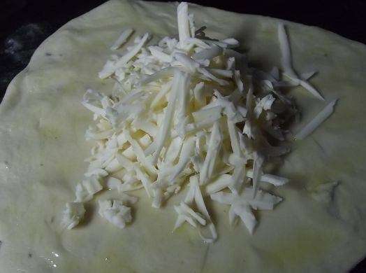 1. Этап. Кукурузные лепешки в духовке: 3. Тесто разделяю на несколько частей, каждую раскатываю в лепешку и смазываю оливковым маслом. В центр добавляю натертый сыр.