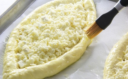 1. Этап. Хачапури по-грузински с сыром: 10. Взбейте 1 яйцо и смажьте края теста. Отправьте противень в разогретую до 200 градусов духовку минут на 15.