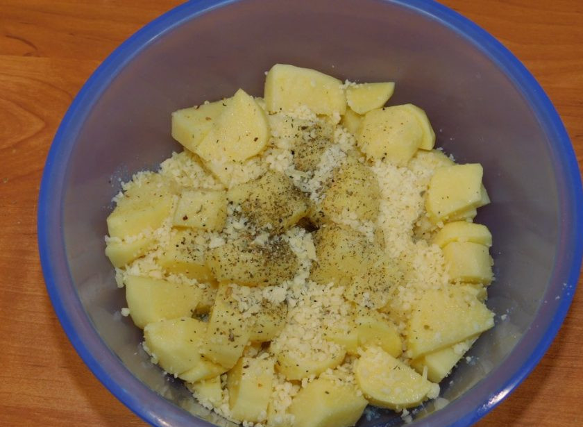 1. Этап. Картошка в духовке от Джейми Оливера: Смешайте картофель с оливковым маслом. Добавьте половину тертого пармезана, соль и специи. Перемешайте.