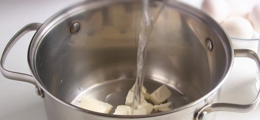 1. Этап. Пончики заварные по-французски: 1. В кастрюлю налейте воду, добавьте сливочное масло и поставьте на небольшой огонь. Доведите массу до кипения и снимите с огня, масло должно полностью раствориться.