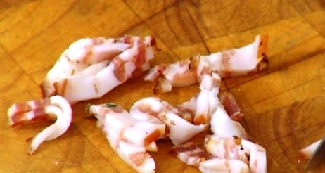 1. Этап. Цыплята в духовке: Порежьте 70 г грудинки на маленькие кусочки.