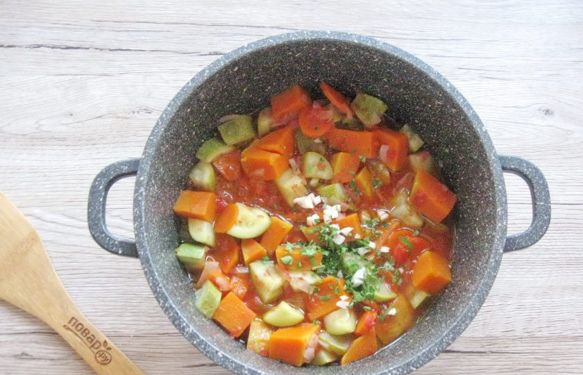 1. Этап. Овощное рагу с тыквой и кабачками: По окончании добавьте в готовые овощи измельчённый чеснок и нарезанную зелень петрушки или укропа, перемешайте рагу.