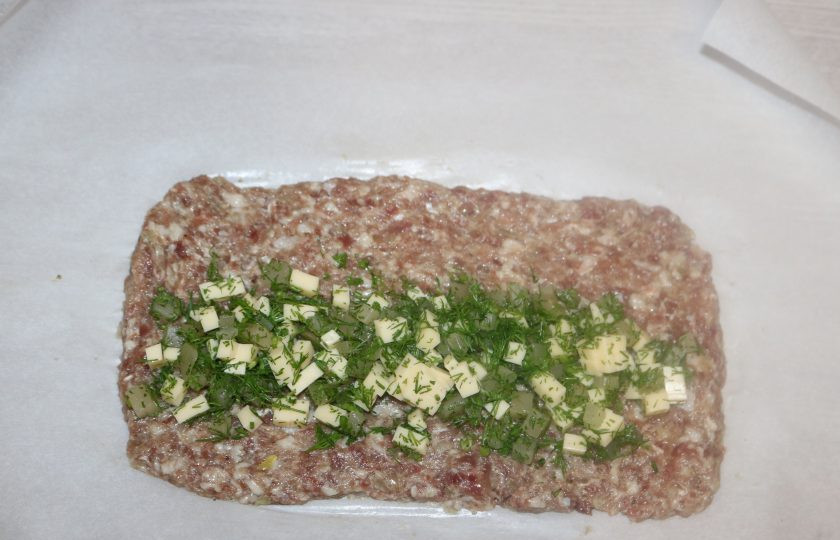 1. Этап. Мясной рулет с ананасами: Выложите начинку на фарш.