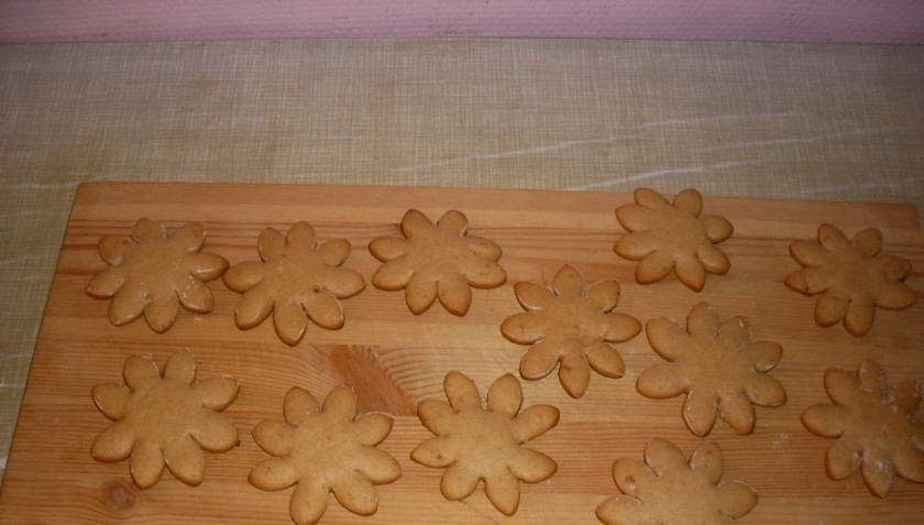 1. Этап. Рождественское печенье с имбирем: Духовку разогрейте до ста восьмидесяти градусов. Запекайте в ней печенье десять-пятнадцать минут, постоянно проверяя его готовность. Изделия тонкие, поэтому могут быстро сгореть. Готовые печеньки достаньте из духовки, дайте им остыть.