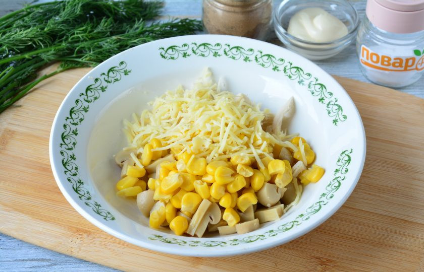 1. Этап. Салат с маринованными грибами и кукурузой: Всыпьте сыр и консервированную кукурузу.