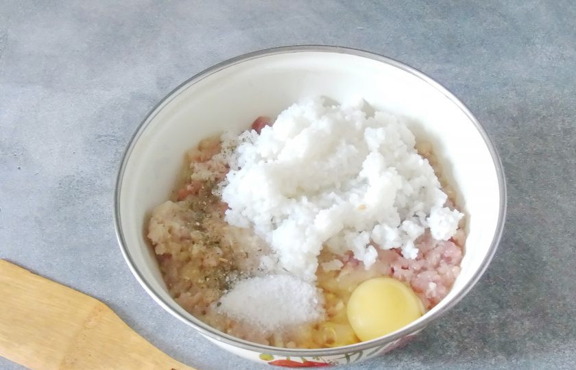 1. Этап. Тефтели с рисом как в детском саду: В миску с фаршем и рисом разбейте яйцо. Посолите по вкусу