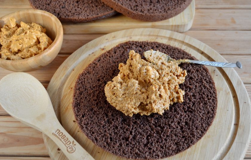 1. Этап. Шоколадный торт с орехами: 11. На первый корж положите половину орехового крема, распределите равномерно.