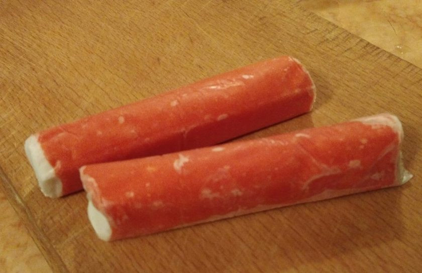 1. Этап. Омлет с крабовыми палочками для диеты Дюкана: 4. Поскольку крабовые палочки — продукт, разрешенный известным диетологом, они отлично дополнят наш омлет. Нарезаем их кольцами, а тем временем разогреваем сковороду с антипригарным дном. Сковороду можно немного смазать растительным маслом.