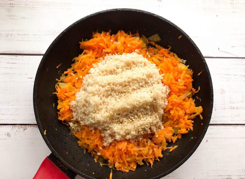 1. Этап. Рыба с рисом и овощами в духовке: Промытый рис выложите к овощам, хорошо перемешайте и обжарьте 2-3 минуты.