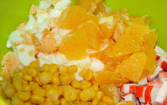 1. Этап. Крабовый салат с апельсинами: 6. Добавьте в салатник кукурузу и апельсин. Заправьте небольшим количеством майонеза и аккуратно перемешайте. Все, аппетитный и оригинальный крабовый салат с апельсинами в домашних условиях готов к подаче.