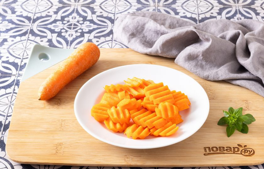 1. Этап. Теплый салат с морковью и горошком: Морковь помойте, очистите от кожуры и порежьте ломтиками толщиной примерно 1 см. Я использую для нарезки фигурный нож.