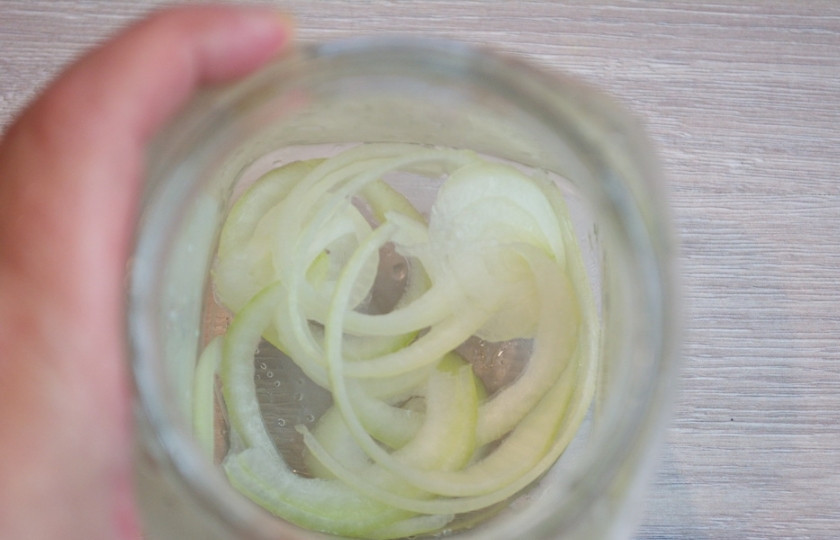 1. Этап. Утопенцы (шпикачка): Возьмите литровую банку. Хорошо ее промойте и обсушите. На дно банки уложите нарезанные луковые кольца. Высота лука в банке должна быть не менее 1 см.