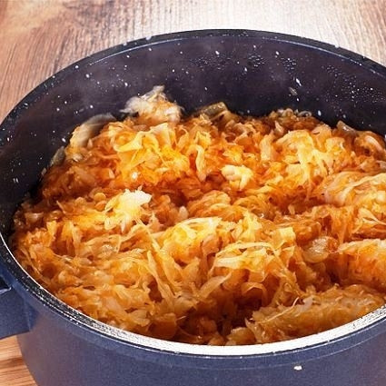 1. Этап. Слоеная капуста по-трансильвански: Берем толстодонную кастрюлю или гусятницу. Обжариваем в ней мелко нарезанный лук до румяности, затем добавляем в кастрюлю капусту и паприку. Наливаем в кастрюлю примерно стакан воды или бульона и тушим капусту 10-15 минут.