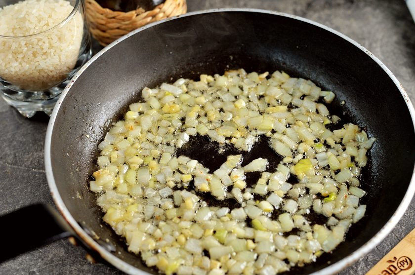 1. Этап. Ризотто с артишоками: Переложите артишоки на тарелку, в это же масло выложите нарезанный мелким кубиком репчатый лук и чеснок. Обжарьте их около минуты на умеренном огне до мягкости.