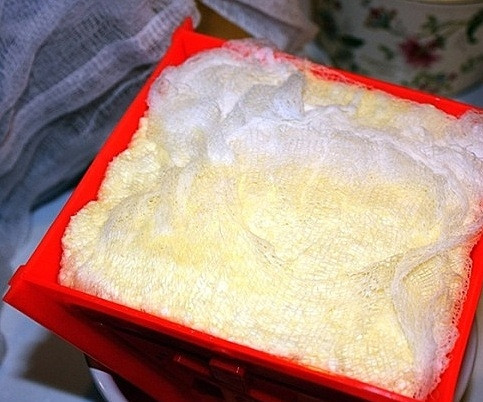 1. Этап. Пасха из молока: Установим форму в какой-нибудь посуде, сверху разместим небольшой гнет.