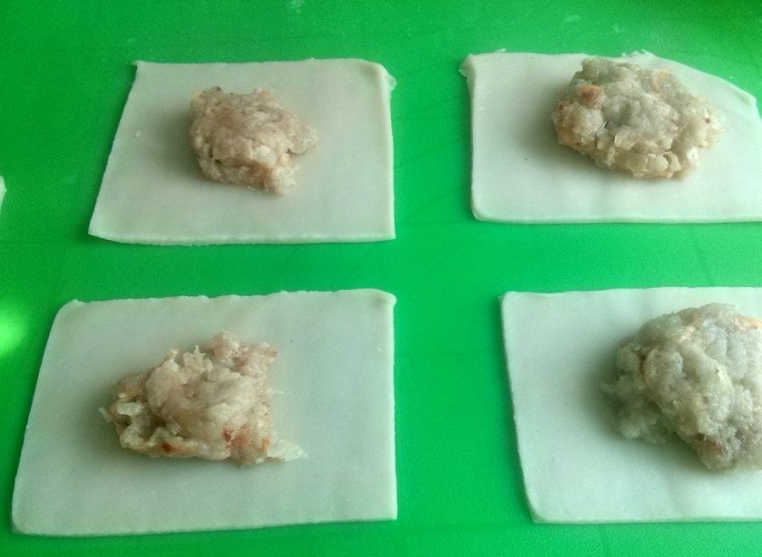 1. Этап. Манты с тыквой и мясом в мультиварке: Разделите тесто на две части, чтобы удобнее было раскатывать. Раскатайте тесто тонким пластом и разрежьте на одинаковые квадраты. В центр каждого положите начинку.