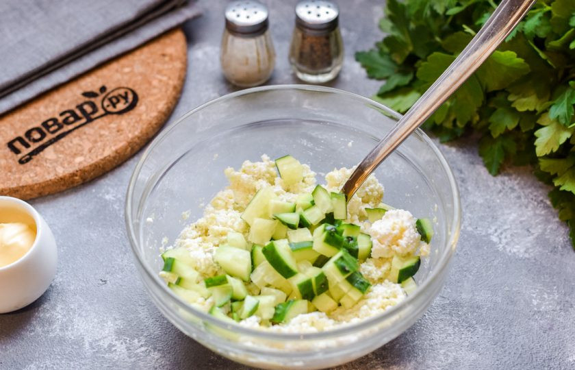 1. Этап. Тарталетки с авокадо и крабовыми палочками: Свежий огурец сполосните, просушите, нарежьте мелкими кубиками и добавьте в миску.