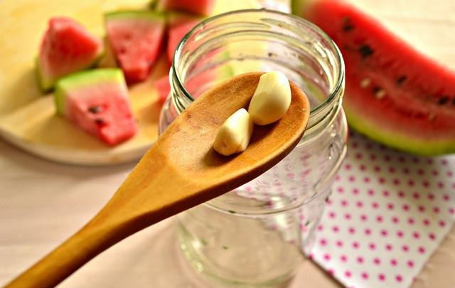 1. Этап. Консервация арбузов: 4. Простерилизуйте баночку и выложите чеснок на дно.