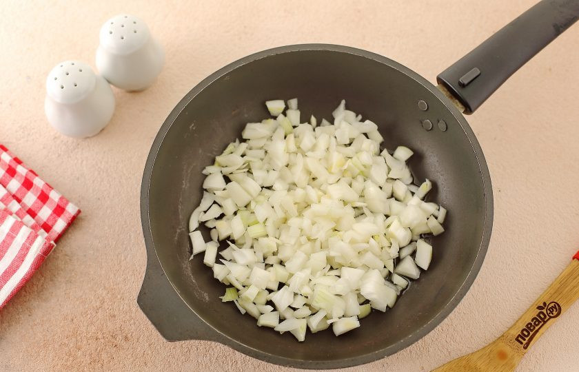 1. Этап. Сметанно-молочный соус: В сковороде разогрейте масло и выложите нарезанный кубиками лук.