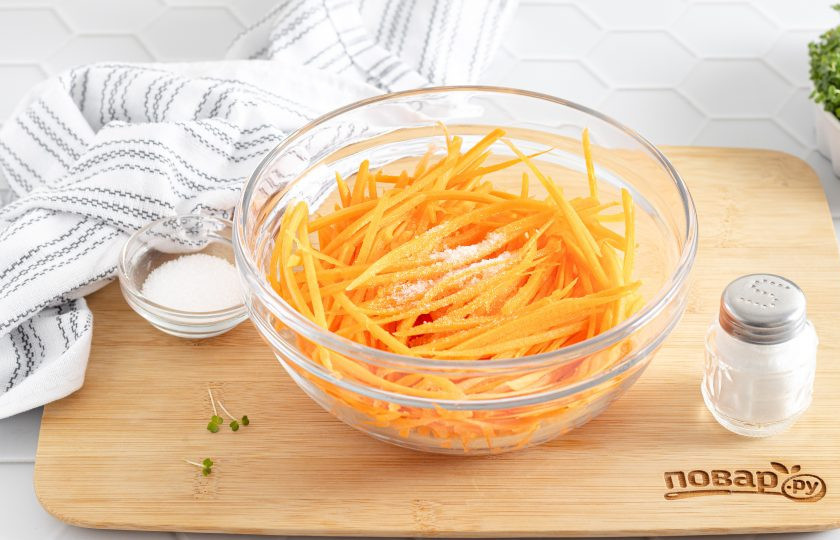 1. Этап. Морковь по-корейски домашняя с приправой: Добавьте сахар и соль, обомните руками, чтобы морковь дала сок.