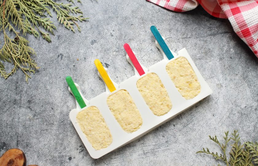 1. Этап. Пирожное Эскимо: Бисквитной массой заполните силиконовые формочки для эскимо и вставьте палочки. Уберите формочки с бисквитной массой в морозильную камеру на два часа. За это время заготовки застынут и отлично извлекутся из формы.