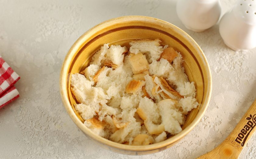 1. Этап. Фрикадельки в соусе Бешамель: Батон раскрошите руками, залейте холодной водой, а потом отожмите.