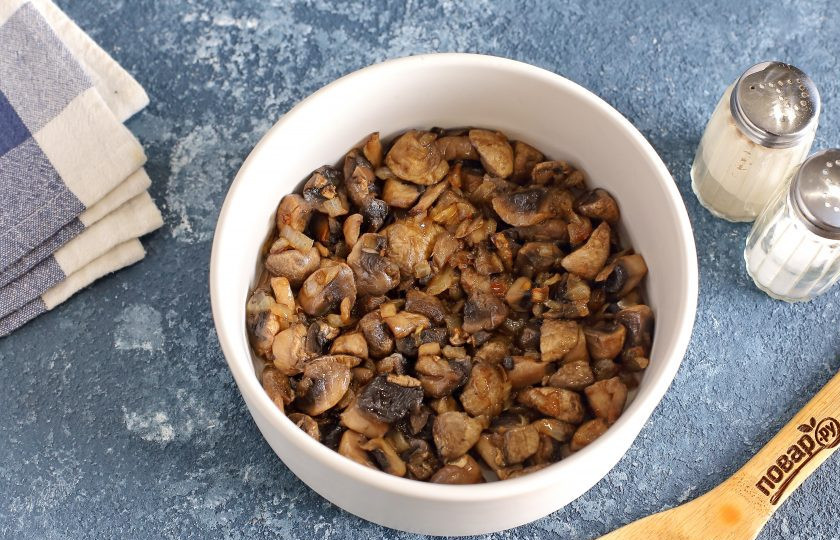 1. Этап. Слоеный салат с окорочком: Салат будем собирать слоями, можно при помощи кулинарного кольца или просто в глубоком салатнике. Каждый слой смазывайте майонезом и солите по вкусу. Первым слоем выложите обжаренные с луком грибы.