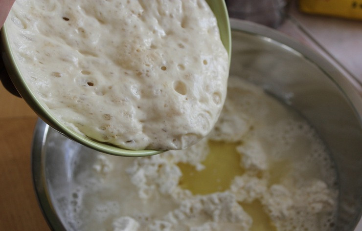 1. Этап. Чиабатта с луком: Вливаем к муке стакан теплой воды, оливковое масло и добавляем опару.