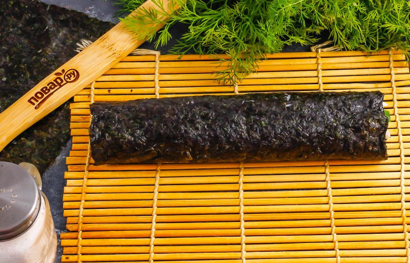 1. Этап. Темпура роллы: Незаполненный край водорослей смажьте водой. Аккуратно скрутите ролл с помощью коврика.