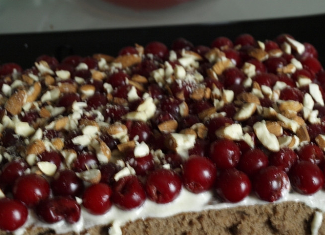 1. Этап. Торт Вишневый поцелуй: 9. Одну пропитываем вишневым соком с алкоголем, кладем крем, вишню и рубленный миндаль. Второй корж пропитываем и накрываем первый. Сверху и по бокам промазываем все кремом.