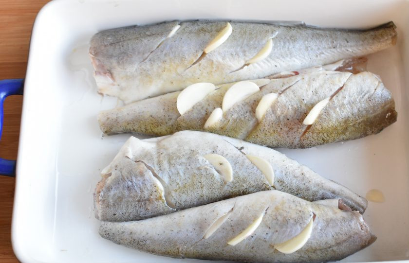 1. Этап. Рыба с чесноком по-болгарски: Сделать на тушках косые надрезы глубиной около двух сантиметров. Вложить в надрезы тоненькие ломтики чеснока. Уложить рыбу в смазанную форму, полить сверху маслом и запечь при 200 градусах в течение 15-20 минут, в зависимости от размера рыбы. Не пересушите рыбу, она готова, как только мясо станет насквозь матовым.