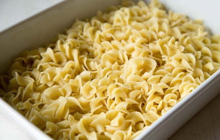 1. Этап. Запеканка из лапши и курицы: 6. Возьмите форму для запекания, выложите на дно лапшу и распределите ее в один слой.