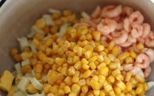 1. Этап. Салат с рисом и кукурузой: Креветки у меня были уже очищенные и отваренные. Если у вас они охлажденные и сырые - отварите их в слегка подсоленной воде минуты 3-4. В миску, в которой будем делать салат, выкладываем кукурузу, креветки и нарезанные яйца.