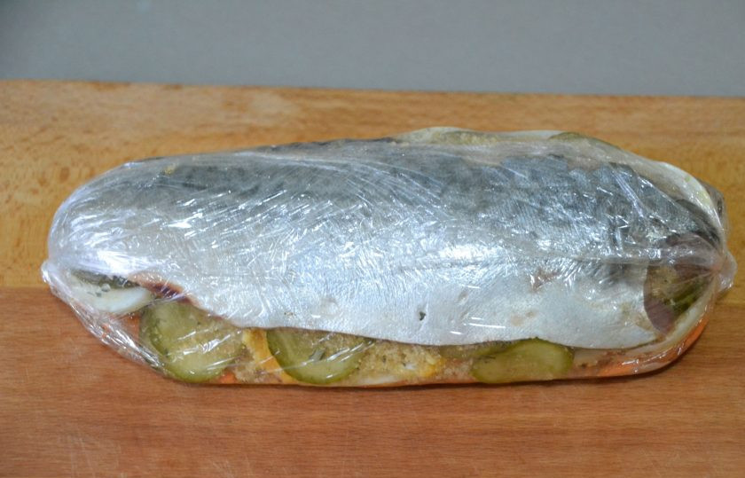 1. Этап. Скумбрия по-царски: Оберните скумбрию плотно пищевой плёнкой, на которой она лежала. Сделайте еще один слой плёнки.