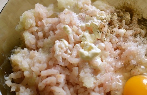 1. Этап. Рыбные котлеты из судака: Кусочек хлеба положите в пиалочку и залейте сливками. Они обязательно должны быть жирными, чтобы котлеты не получились сухими. Рыбное филе пропустите через мясорубку вместе с очищенным луком. Можно измельчить ингредиенты в блендере. Добавьте фарш к размоченному хлебу. Вбейте сырое куриное яйцо, посолите, поперчите и хорошенько все перемешайте.