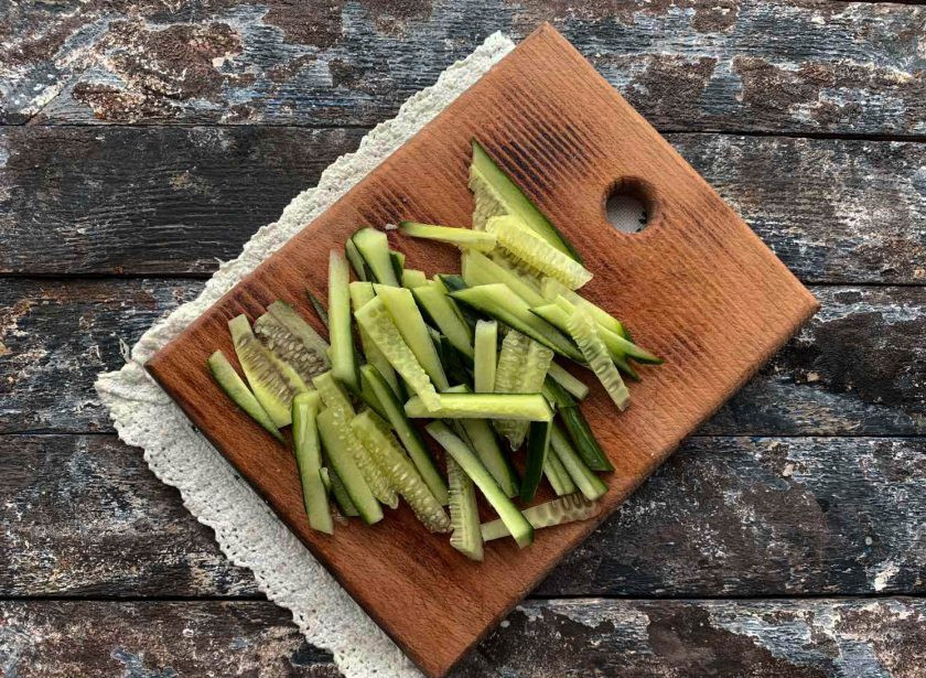 1. Этап. Фунчоза с копченой курицей: Огурец хорошо помойте под проточной водой и нарежьте соломкой.