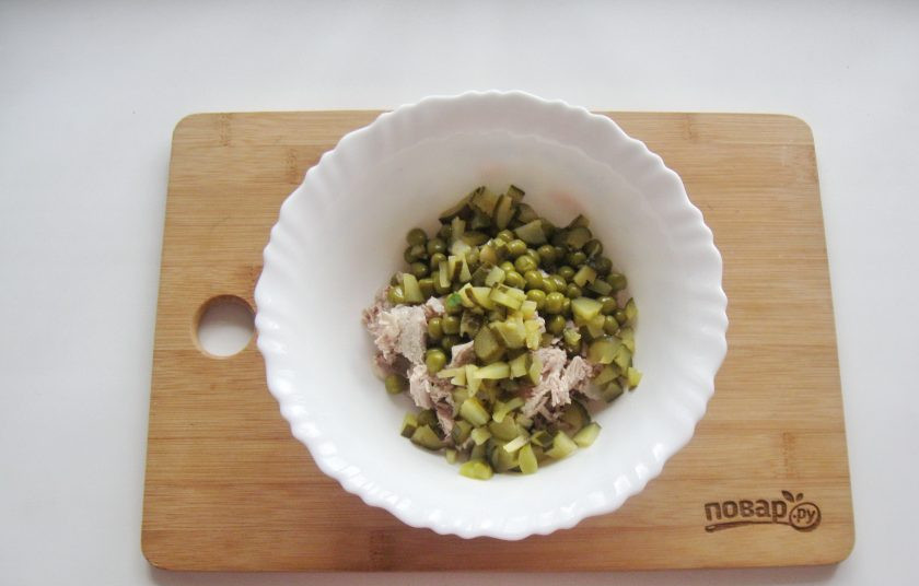 1. Этап. Салат Купеческий на Новый год: Соленый или маринованный огурец нарежьте мелкими кубиками и выложите в салат.