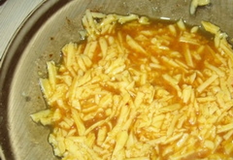 1. Этап. Хек в кляре: Натираем на крупной терке сыр и смешиваем с яйцами.