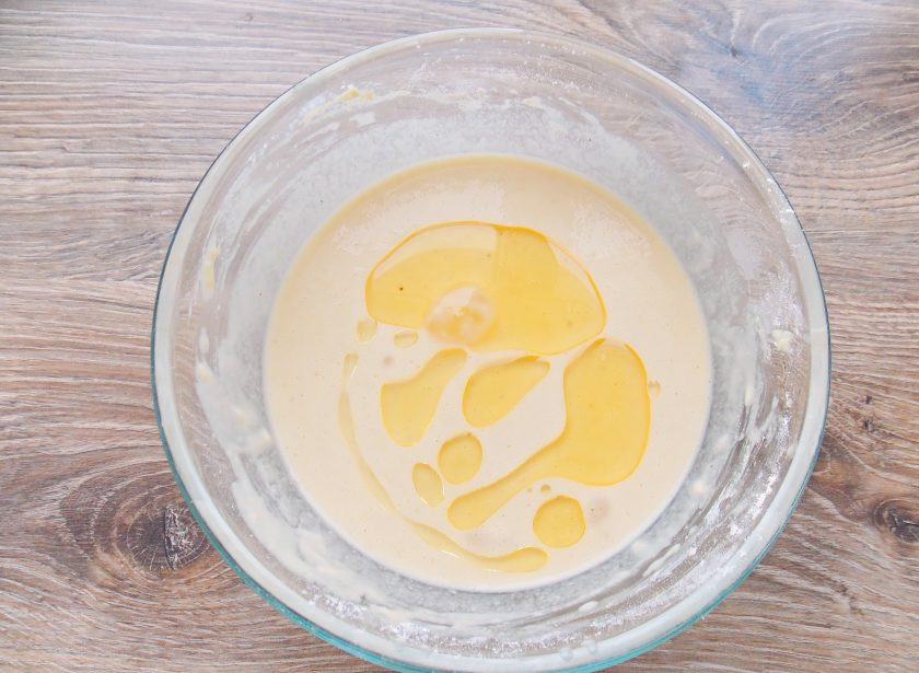 1. Этап. Блины из кукурузной муки на кефире: Влейте 2 столовые ложки растительного масла и перемешайте.