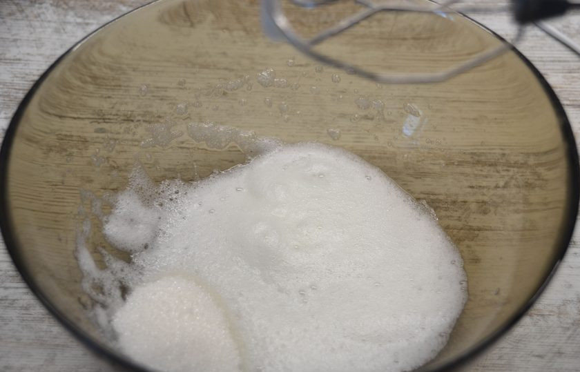 1. Этап. Пирог с грушей и сыром: Отделите белок и желток одного яйца. Добавьте к белку половину сахара.