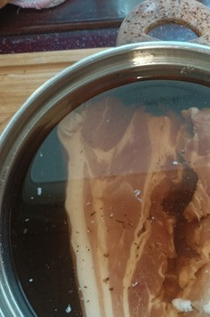 1. Этап. Грудинка запеченная в духовке: В кастрюлю наливаем 1,5 л. воды, всыпаем соль, крошим лавровые листики. Добавляем орегано, тимьян, розмарин. Доводим до кипения. Снимаем с огня и остужаем до комнатной температуры. Погружаем грудинку в рассол и даем просолиться 12 часов.