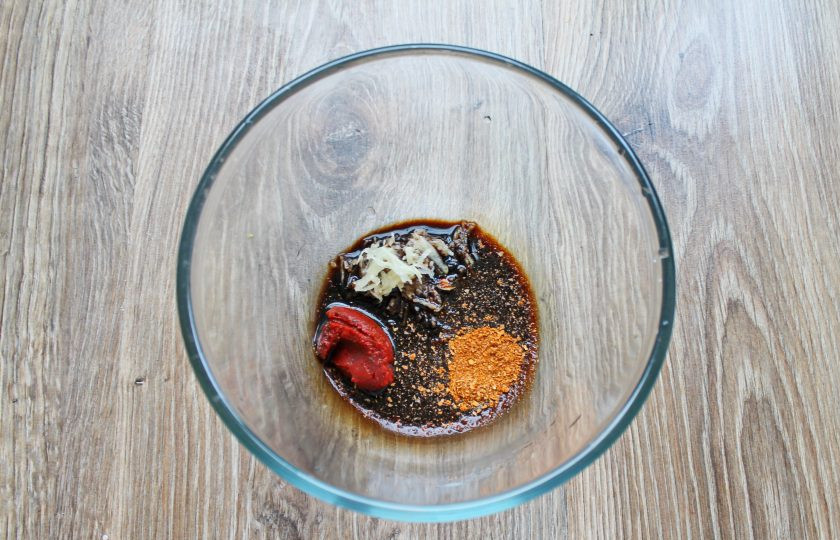 1. Этап. Куриные леденцы: В миске смешайте соевый соус, томатную пасту, аджику, тертый чеснок и молотый перец.