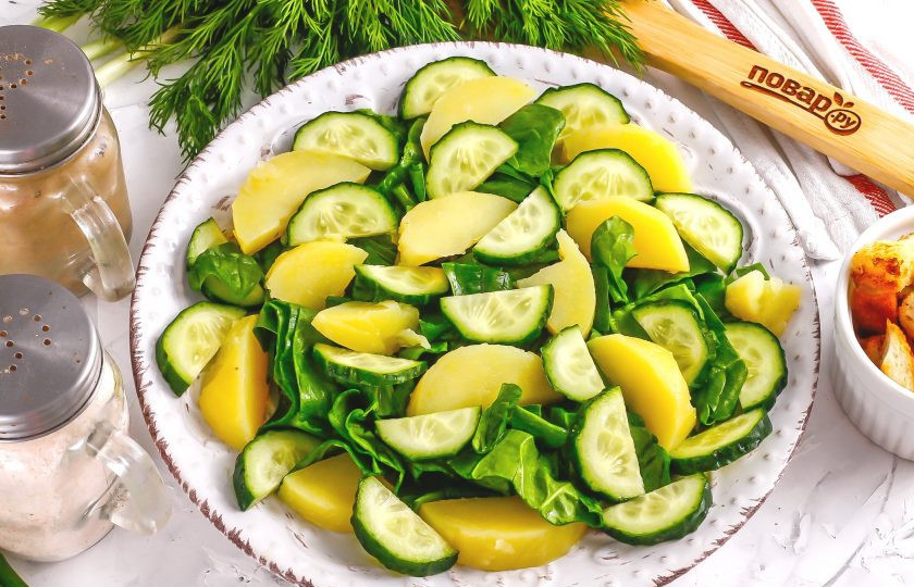 1. Этап. Салат с тунцом и сухариками: Промойте огурец, срежьте хвостики и нарежьте половину овоща полукольцами, выложите на тарелку.