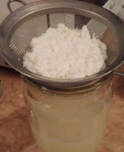 1. Этап. Домашний творожок из кефира 2,5%: 5. Вылейте содержимое в ситечко. Сыворотка уйдет в банку, а творожок останется на ситечке.