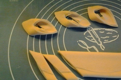 1. Этап. Крымская пахлава: Заворачиваем пласт теста в рулет с помощью скалки. Скалку вынимаем и свободный край теста слегка прищипываем, чтобы тесто не развернулось при жарке. Нарезаем рулет под углом на кусочки примерно 2 см толщиной.