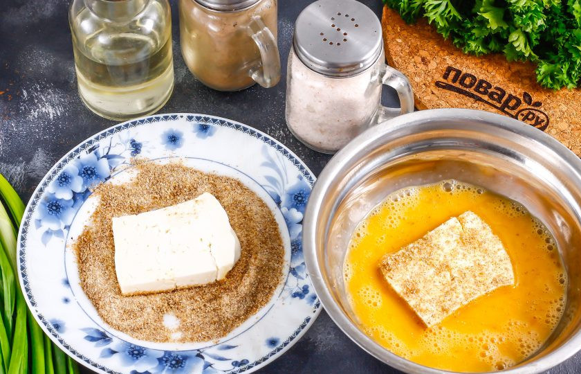 1. Этап. Брынза в кляре: Нарежьте сыр крупными квадратами или прямоугольниками, обсушите каждый из них бумажной салфеткой от рассола. Обпанируйте нарезку сначала в сухарях, затем в яйце и снова в сухарях. Помните, это нужно делать, когда сковорода с маслом прогреется на плите.